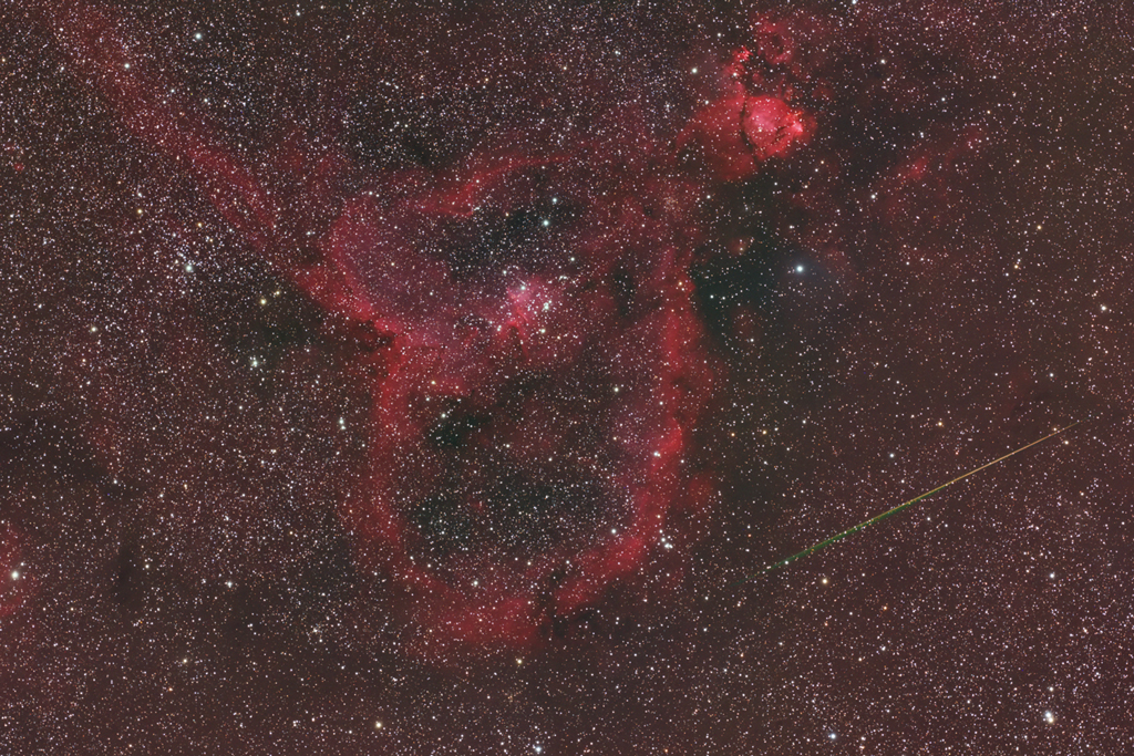 The Heart Nebula (IC 1805) pierced by a Perseid meteor. Taken with a Takahashi FSQ-106EDX-III telescope and an FLI ML11002-C camera.